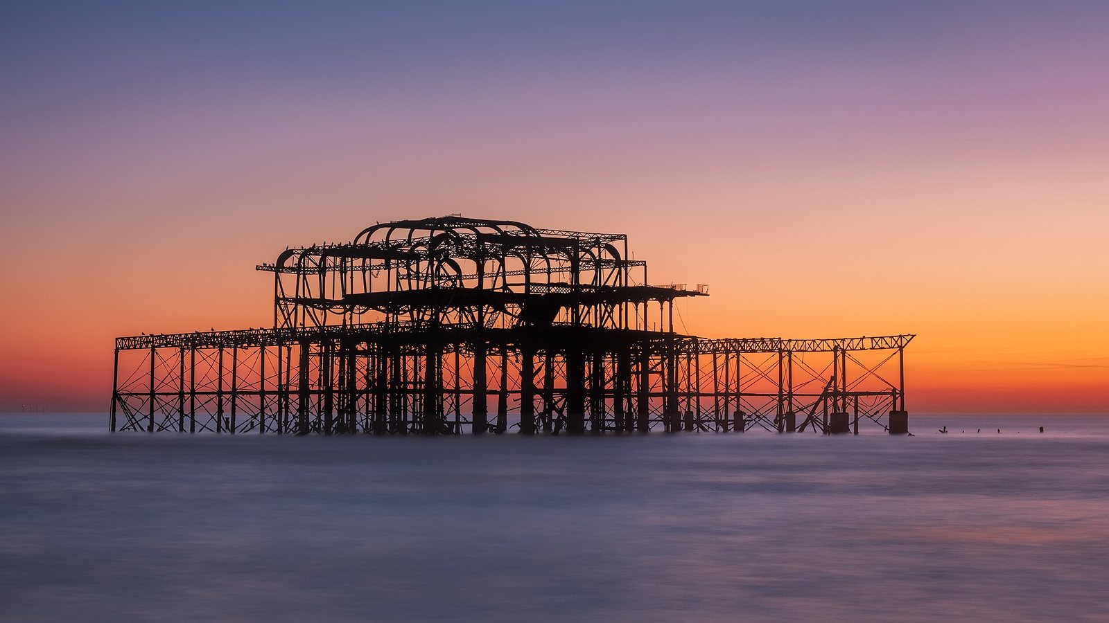 Brighton West Pier: Tide bears the last glow - Brighton, UK by sagesolar