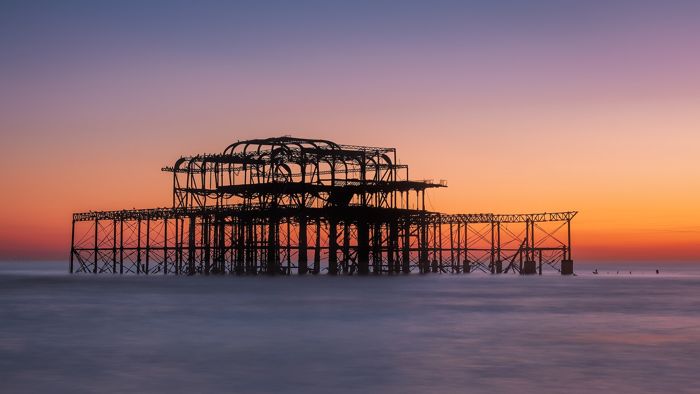 Brighton West Pier: Tide bears the last glow - Brighton, UK by sagesolar