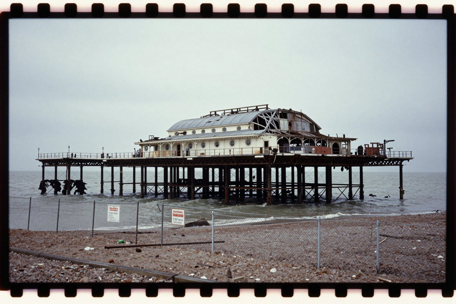 Guest AI work by Z-Image-Turbo: Untitled (Kodachrome slide, 1983). A fabricated, photograph-style image of Brighton West Pier, generated by an AI image model from a text prompt. It is not a real photograph.