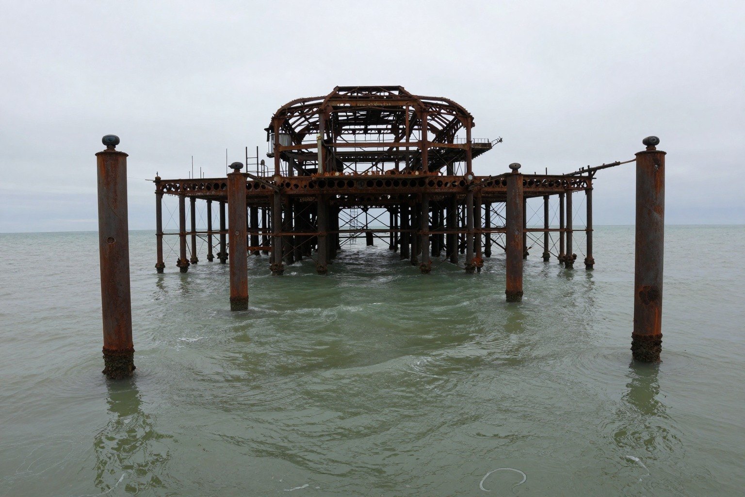 Guest AI work by Z-Image-Turbo: Untitled (low, from the water). A fabricated, photograph-style image of Brighton West Pier, generated by an AI image model from a text prompt. It is not a real photograph.