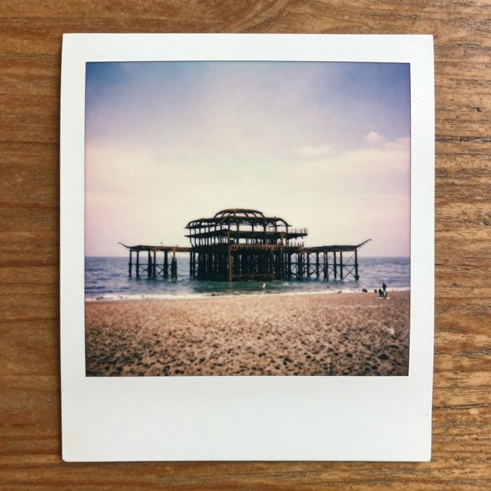 Guest AI work by Z-Image-Turbo: Untitled (Polaroid on a kitchen table). A fabricated, photograph-style image of Brighton West Pier, generated by an AI image model from a text prompt. It is not a real photograph.