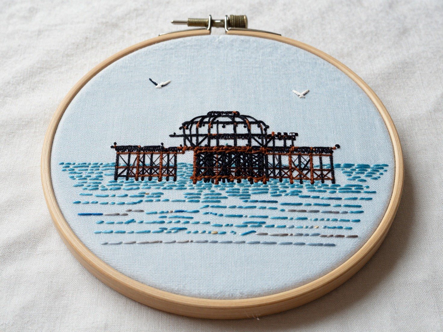 Guest AI work by Z-Image-Turbo: Untitled (embroidery in a hoop). A fabricated painting, drawing or print of Brighton West Pier, generated by an AI image model from a text prompt. It is not a real artwork.